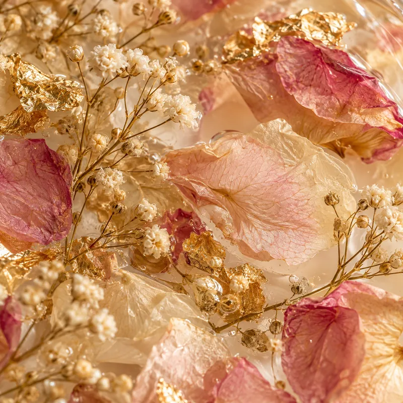 Dried baby's breath and rose petals sealed in clear resin